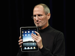 Steve Jobs holding an iPad