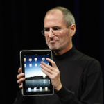 Steve Jobs holding an iPad